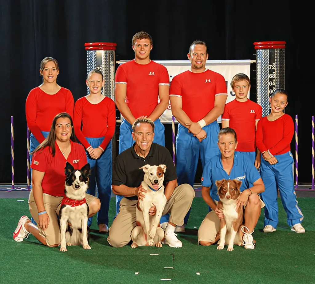 Group of people and dogs on stage.